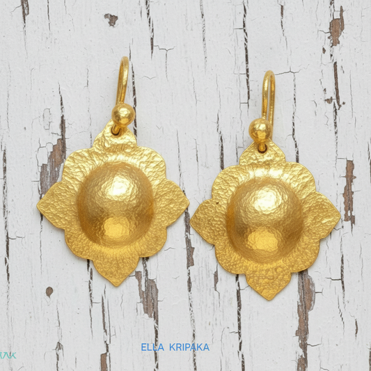 24k gold hammered Byzantine baroque convex earrings with shiny gold textures are on white old wooden background, artist-jeweler's name 'Ella Kripaka' vranding