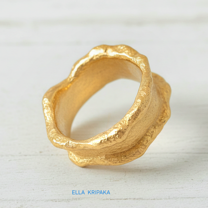 Organic 24k gold hammered ring with textured surface and uneven edges on a white craft  paper background, branded 'Ella Kripaka'