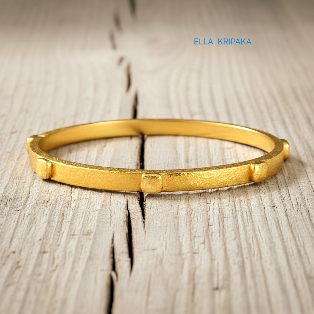 24k gold hammered bangle textured bracelet with thick squares on light rustic wooden surface, artist 'Ella Kripaka' branding