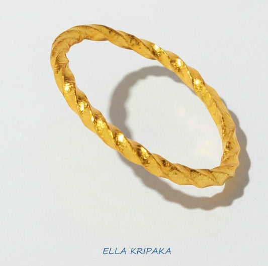 Twisted Viking Hammered 24k 9999 Gold bangle bracelet on white wooden surface, artist's name 'Ella Kripaka' branding