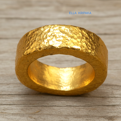Hammered 24k 9999 Gold thick ring Ancient Rome style with a textured forged gold surface on a old wooden background, branded 'Ella Kripaka'