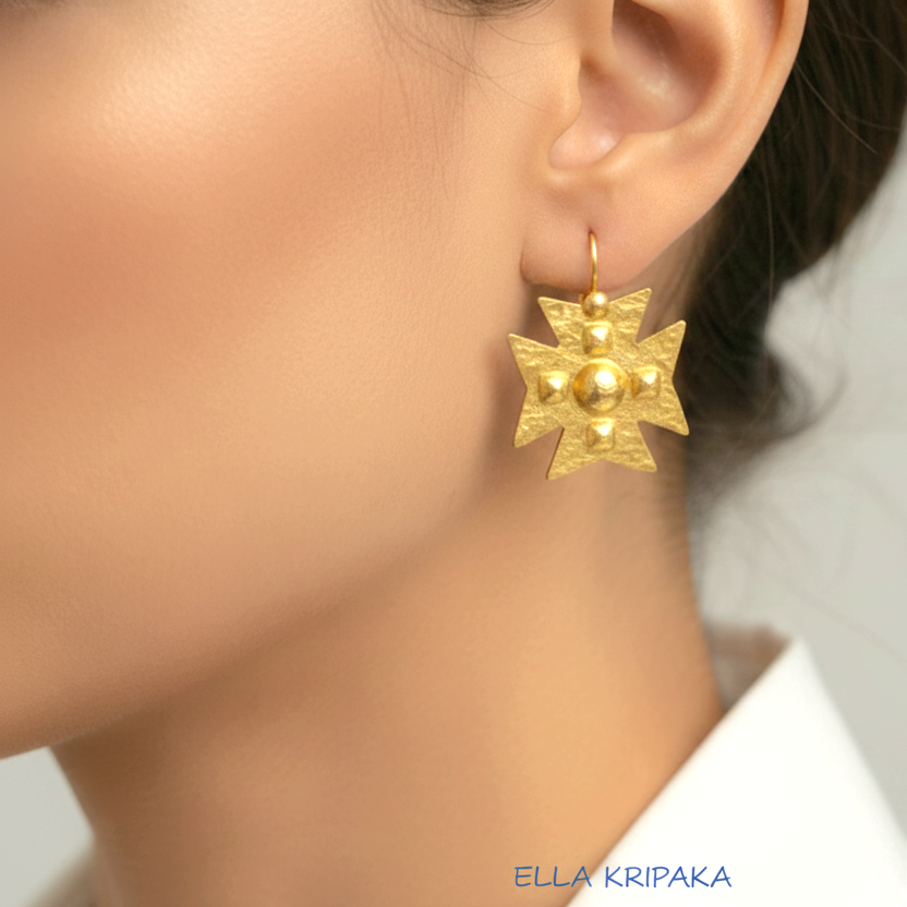 Hammered 24k 9999 Gold Byzantine cross earrings worn by a woman on a neutral background with 'Ella Kripaka' branding