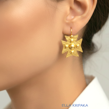 Hammered 24k 9999 Gold Byzantine cross earrings worn by a woman on a neutral background with 'Ella Kripaka' branding