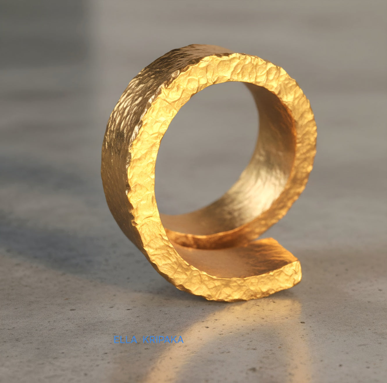 Hammered twisted 24k Gold 9999 gold signet thick ring with textured gold on a grey concrete background, branded 'Ella Kripaka'