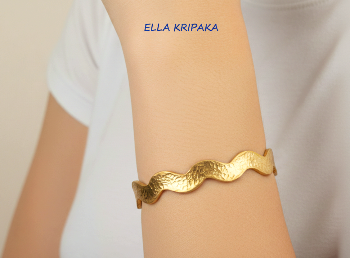 Wavy Hammered 24k 9999 Gold bangle bracelet worn on person's hand, artist's name 'Ella Kripaka' branding