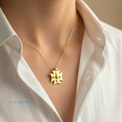 24k gold Byzantine cross pendant textured hammered with convex pattern and with chain is worn by a woman and with white shirt, with 'Ella Kripaka' branding