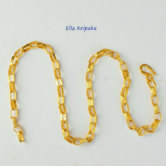 Hammered 24k chain necklace as in Ancient Rome on a white paper background, branding artist name 'Ella Kripaka'