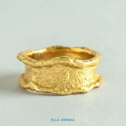 Organic 24k gold hammered ring with textured surface and uneven edges on a white craft  paper background, branded 'Ella Kripaka'