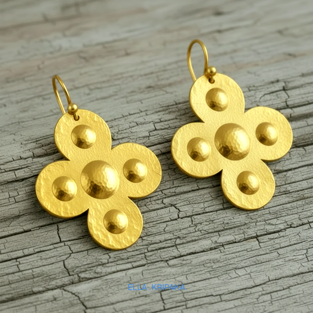 Hammered 24k 9999 Gold Byzantine cross earrings on a old grey wooden background with 'Ella Kripaka' branding