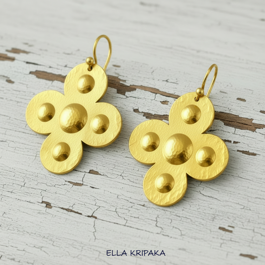 Hammered 24k 9999 Gold Byzantine cross earrings on a old grey wooden background with 'Ella Kripaka' branding