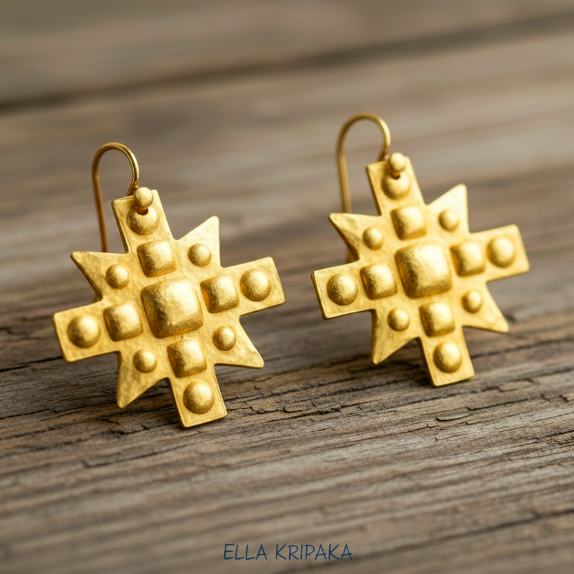 Hammered 24k 9999 Gold Byzantine cross earrings on a old wooden background with 'Ella Kripaka' branding