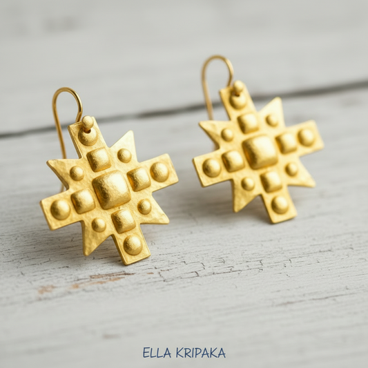 Hammered 24k 9999 Gold Byzantine cross earrings on a old wooden background with 'Ella Kripaka' branding