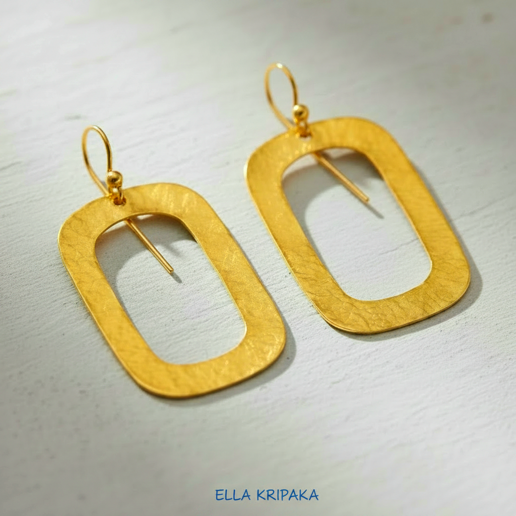 24k gold hammered textured rectangular hoops earrings on light grey craft paper background,  arist-jeweler 'Ella Kripaka' branding