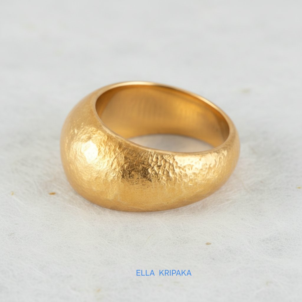 Hammered 24k 9999 Gold ring convex signet Ancient Rome style on white paper surface, artist-jeweler's name 'Ella Kripaka' branding