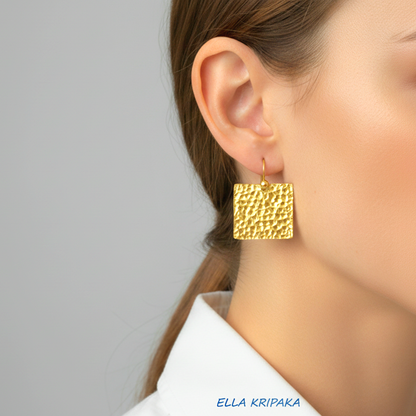 Organic 24k gold hammered textured square earrings worn on a model with a neutral background, artist 'Ella Kripaka' branding