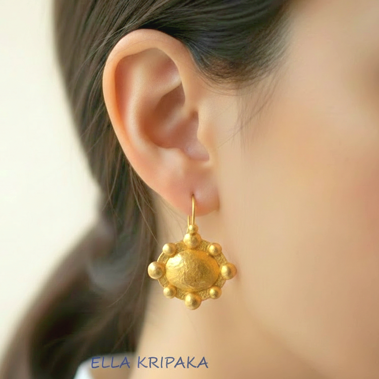 Hammered 24k 9999 Gold Byzantine convex earrings worn by a woman on a neutral background with 'Ella Kripaka' branding