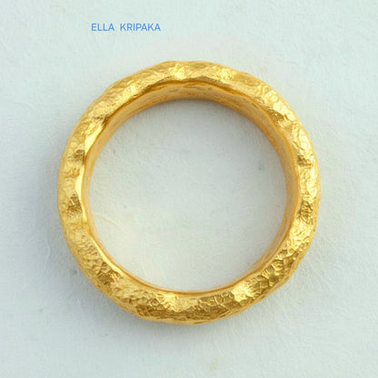 Hammered organic 24k Gold 9999 gold uneven wavy thick ring band with textured gold on a white craft paper background, branded 'Ella Kripaka'
