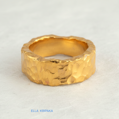 Organic hammered 24k 9999 Gold ring with uneven edges on white paper surface, artist-jeweler's name 'Ella Kripaka' is written in picture