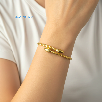 Twisted 24k gold hammered bracelet with thick ends and with textured design is worn by a woman on wrist and on white t-shirt background, branded artist 'Ella Kripaka'