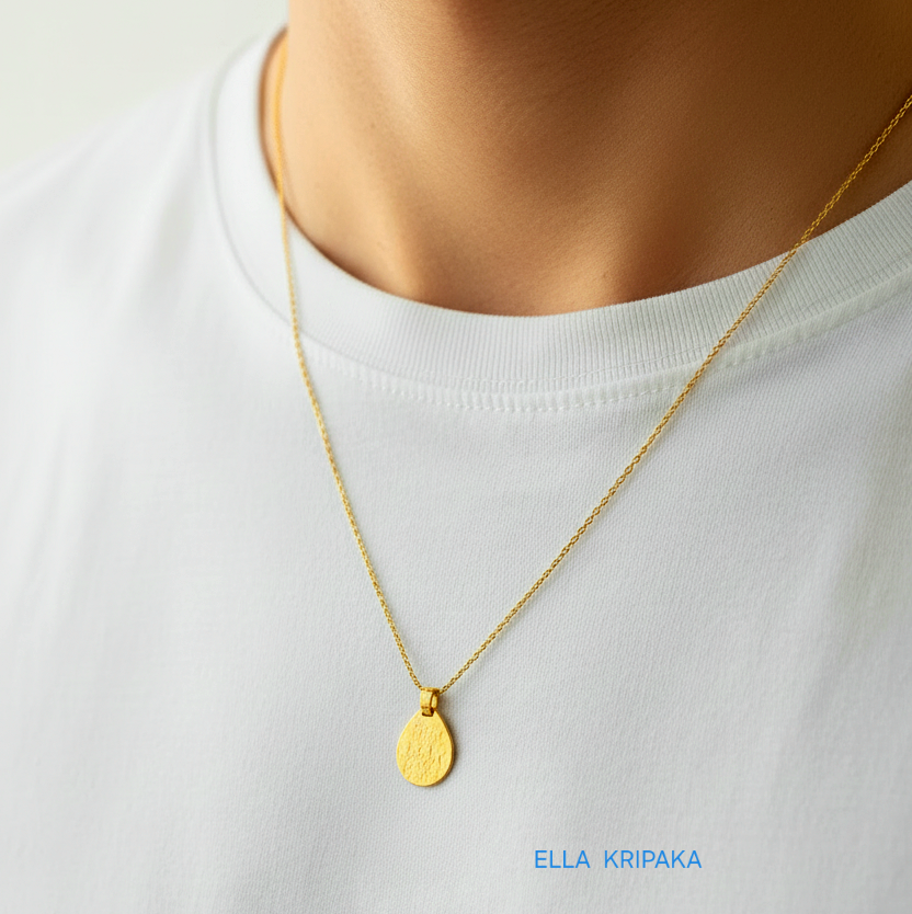 Hammered 24k gold, pure 9999 gold drop pendant on chain worn by a man and with white t-shirt and on grey background, artist-jeweler 'Ella Kripaka' branding