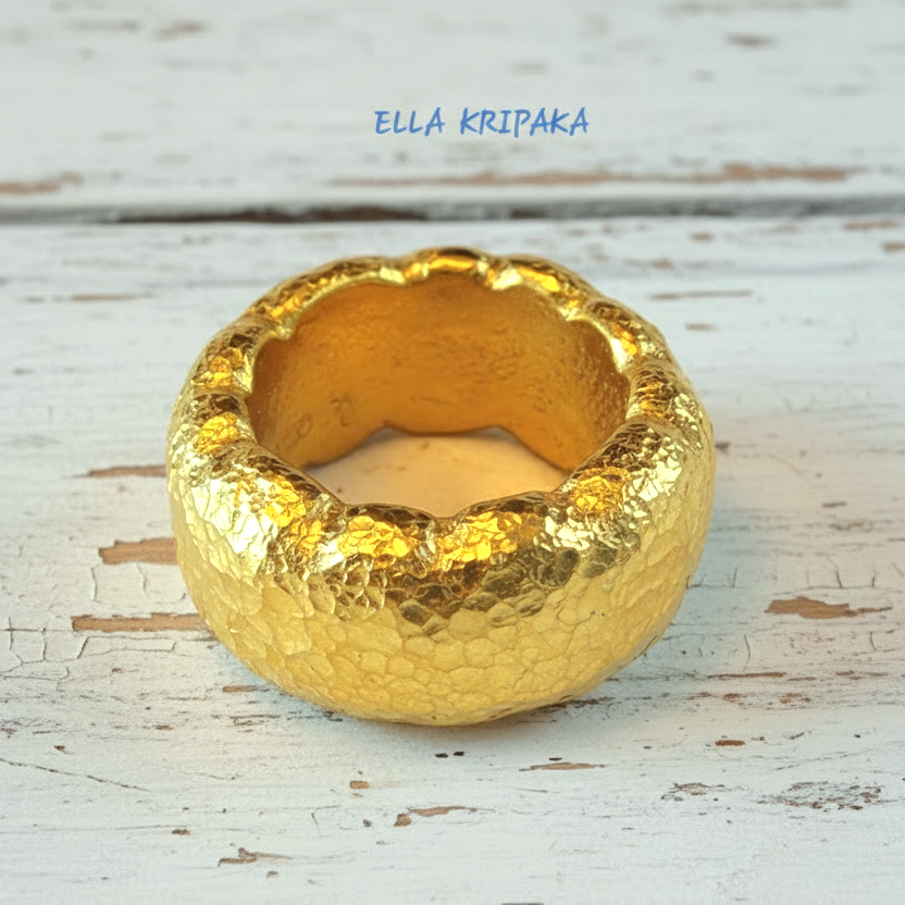 Organic hammered 24k gold 9999 Gold textured wavy thick ring on a wooden surface with 'ELLA KRIPAKA' branding
