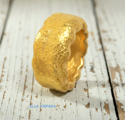 Organic hammered 24k gold 9999 Gold textured wavy thick ring on a rustic wooden surface with 'ELLA KRIPAKA' branding