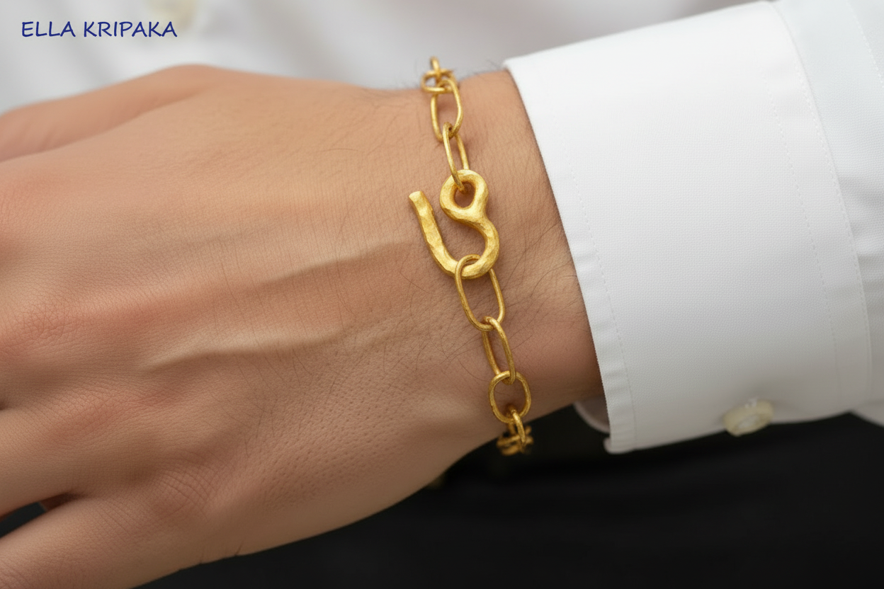 Hammered 22k Gold chain bracelet on a man's wrist with a white shirt, branded artist's name 'Ella Kripaka'