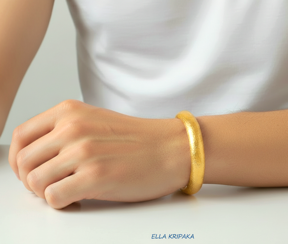 24k 9999 gold hammered cuff bracelet Ancient Rome style worn bt a man on wrist and on a white background, artist-jeweler 'Ella Kripaka' branding