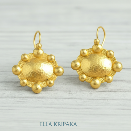 Hammered 24k 9999 Gold Byzantine convex earrings on a old wooden background with 'Ella Kripaka' branding