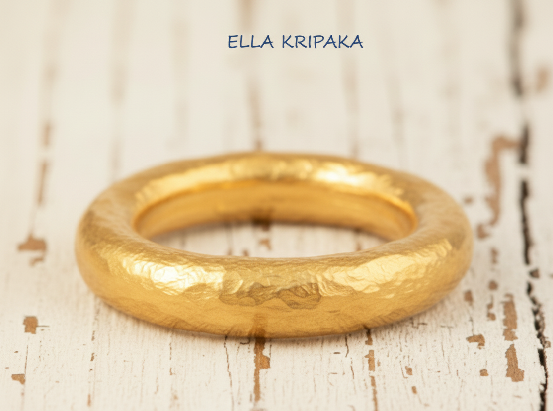 Hammered 24k 9999 Gold ring thick Ancient Rome style on old white wooden surface, artist-jeweler's name 'Ella Kripaka' branding