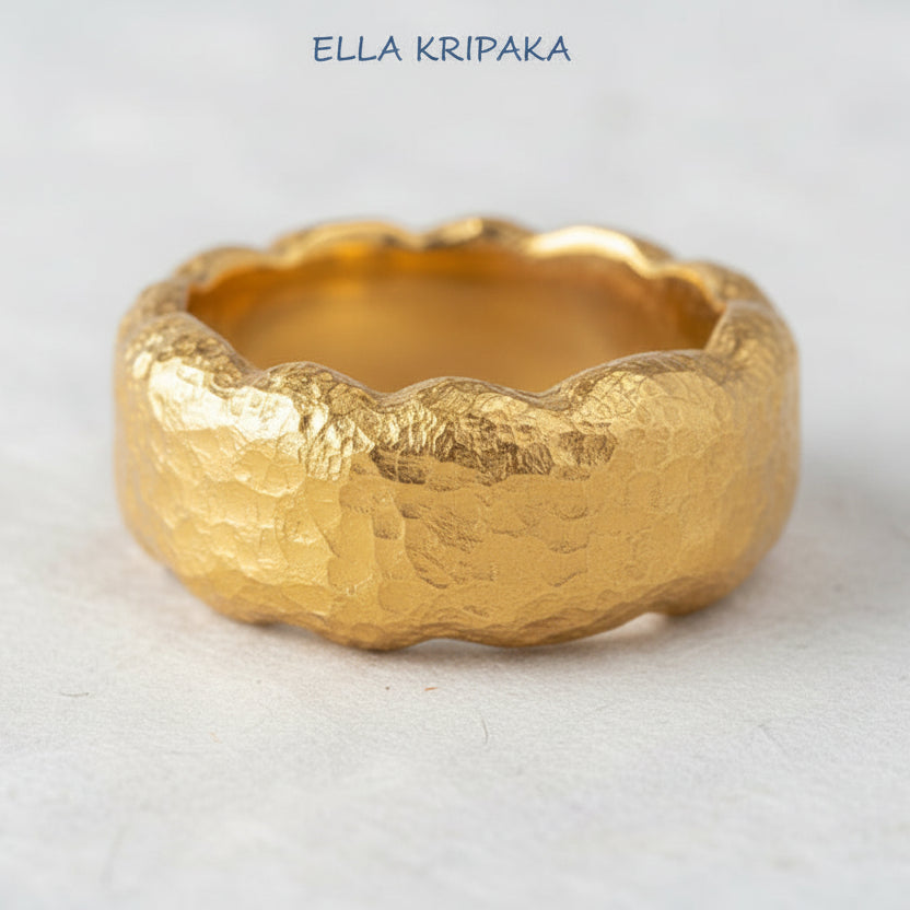 Hammered organic 24k Gold 9999 gold uneven wavy thick ring band with textured gold on a white craft paper background, branded 'Ella Kripaka'