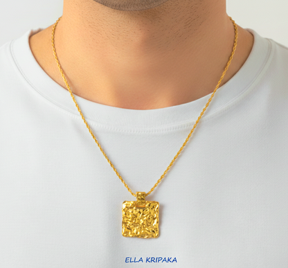 Organic 24k gold wavy textured square pendant hammered with uneven edges and with chain is worn by a model and with white t-shirt background, with 'Ella Kripaka' branding