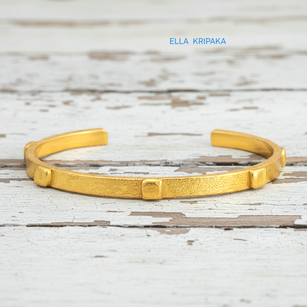 24k gold hammered cuff textured bracelet with thick squares on white rustic wooden surface, artist 'Ella Kripaka' branding