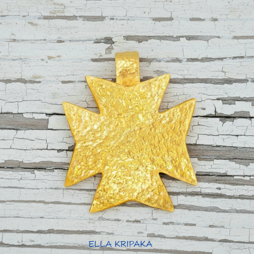 24k gold Byzantine cross pendant textured hammered on old white wooden background, with 'Ella Kripaka' branding