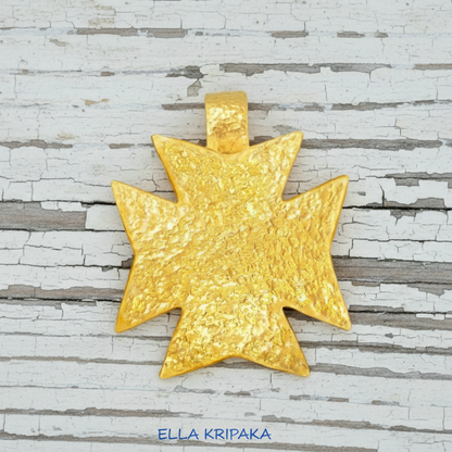 24k gold Byzantine cross pendant textured hammered on old white wooden background, with 'Ella Kripaka' branding