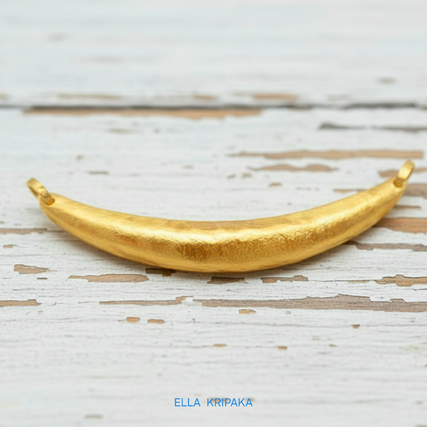 Hammered 24k gold convex Moon pendant on a white rustic wooden background with 'Ella Kripaka' branding
