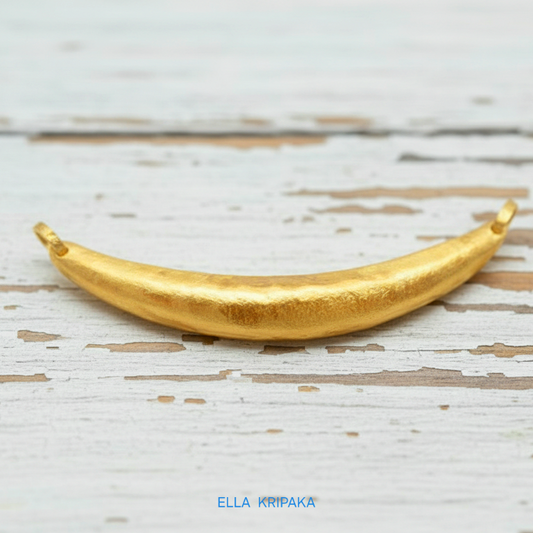 Hammered 24k gold convex Moon pendant on a white rustic wooden background with 'Ella Kripaka' branding