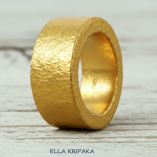 Hammered 24k Gold 9999 gold Ancient Rome  thick ring band with textured gold on a white rustic wooden background, branded 'Ella Kripaka'
