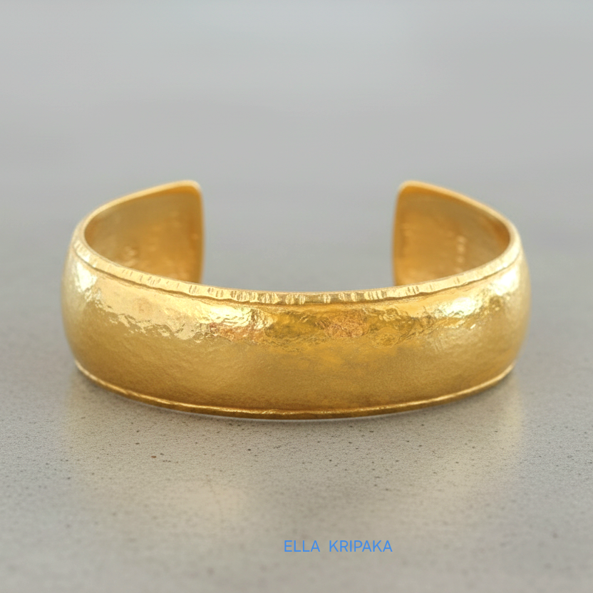 24k 9999 gold hammered Ancient Rome convex  cuff bracelet on a grey concrete surface, branded 'Ella Kripaka'