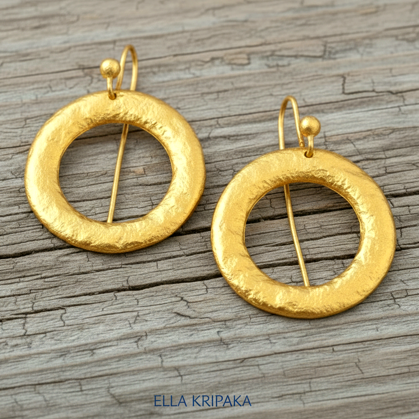 Hammered 24k 9999 Gold convex hoops earrings Ancient Rome and Byzantine style on a old wooden background, and artist-jeweler's name 'Ella Kripaka' branding