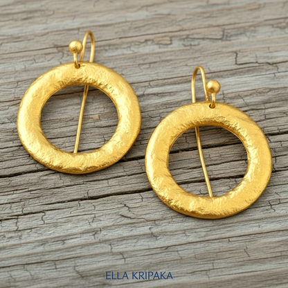 Hammered 24k 9999 Gold convex hoops earrings Ancient Rome and Byzantine style on a old wooden background, and artist-jeweler's name 'Ella Kripaka' branding