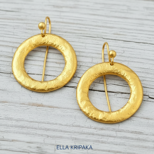 Hammered 24k 9999 Gold convex hoops earrings Ancient Rome and Byzantine style on a old wooden background, and artist-jeweler's name 'Ella Kripaka' branding