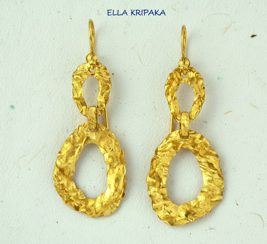 Organic hammered uneven 24k 9999 Gold earrings on a grey surface, and with 'ELLA KRIPAKA' branding