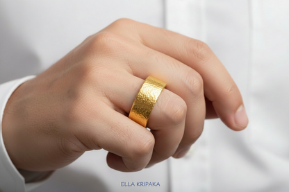 Hammered 24k Gold 9999 gold thick ring  band Ancient Rome style with textured gold worn on person's finger and on a white shirt background, branded 'Ella Kripaka'