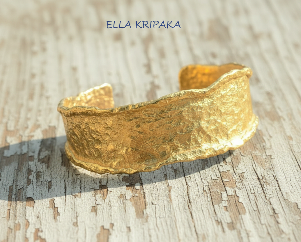 Organic hammered 24k 9999 gold bracelet uneven cuff on a old white wooden background, branding artist-jeweler name 'Ella Kripaka'
