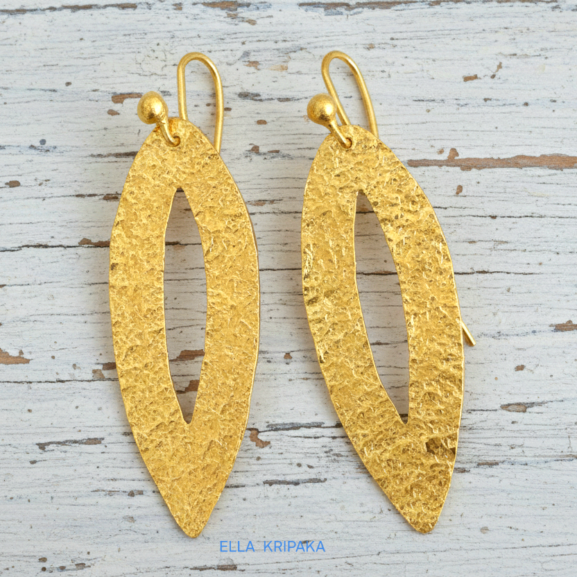 Hammered 24k 9999 Gold Byzantine leaf earrings on a old white wooden background with 'Ella Kripaka' branding
