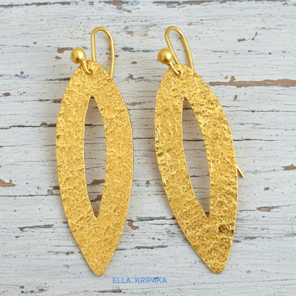 Hammered 24k 9999 Gold Byzantine leaf earrings on a old white wooden background with 'Ella Kripaka' branding